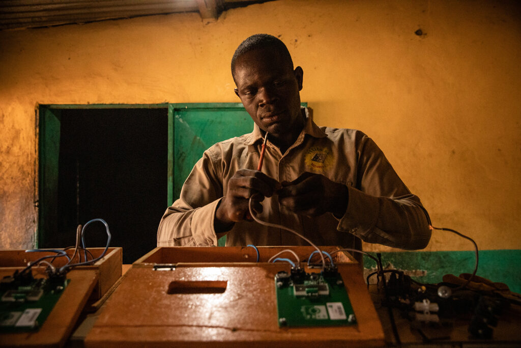 Service technician connects solar home system